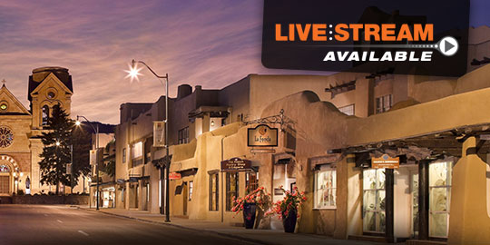 Evening view of the historic La Fonda on the Plaza in Santa Fe, New Mexico, with adobe buildings and people strolling under the "LIVE STREAM AVAILABLE" banner, promoting CME/CE conferences.