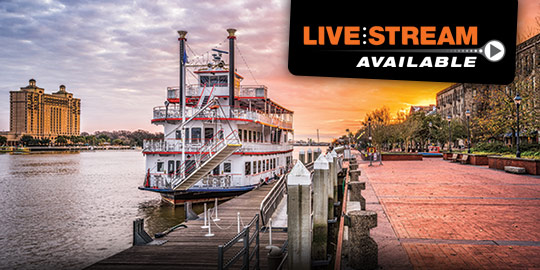 A historic steamboat rests at the riverfront in Savannah, Georgia, with a vibrant sunset illuminating the city's charming skyline. This picturesque setting is the backdrop for engaging CME/CE conferences.