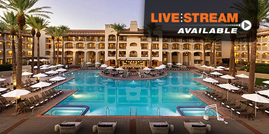 The luxurious pool at the Fairmont Scottsdale Princess, surrounded by palm trees and bathed in the warm glow of the evening sky.