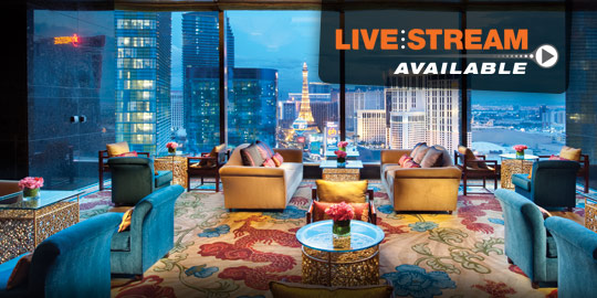 Luxurious Waldorf Astoria Lounge in Las Vegas featuring plush seating, floral carpets, and panoramic views of the Las Vegas Strip for CME/CE conferences